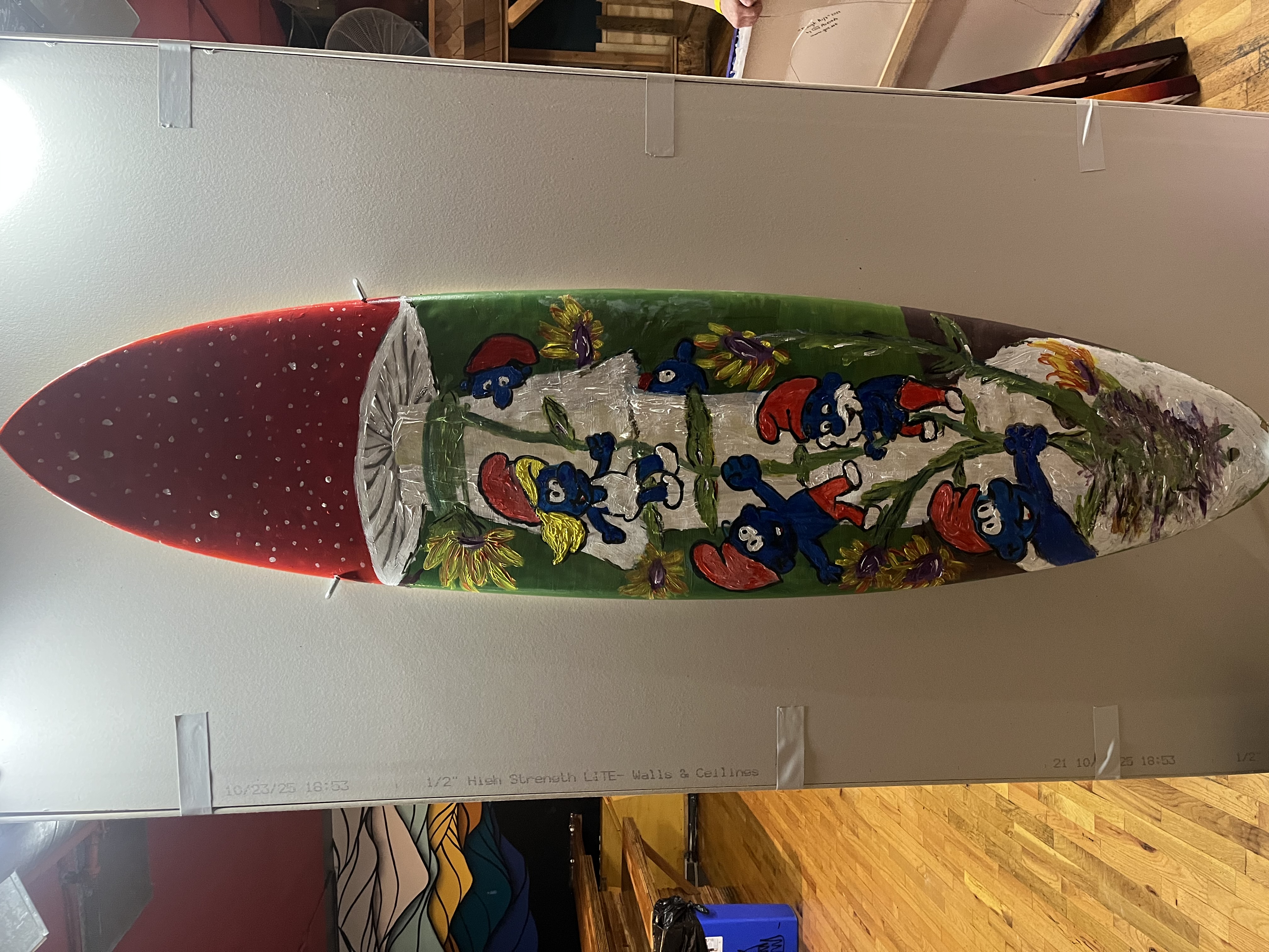 Painted surfboard at Pancakes & Booze art show 'Smurfboard